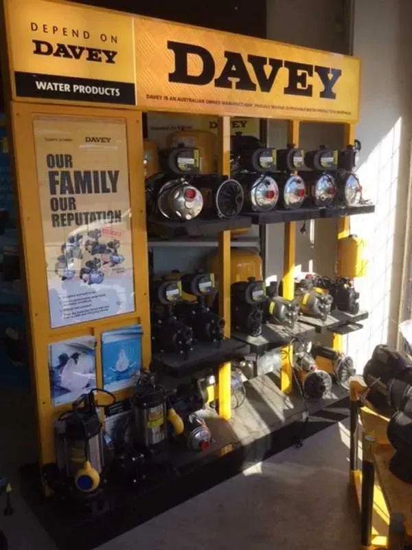 Davey water products display with pumps and a yellow sign in a store aisle