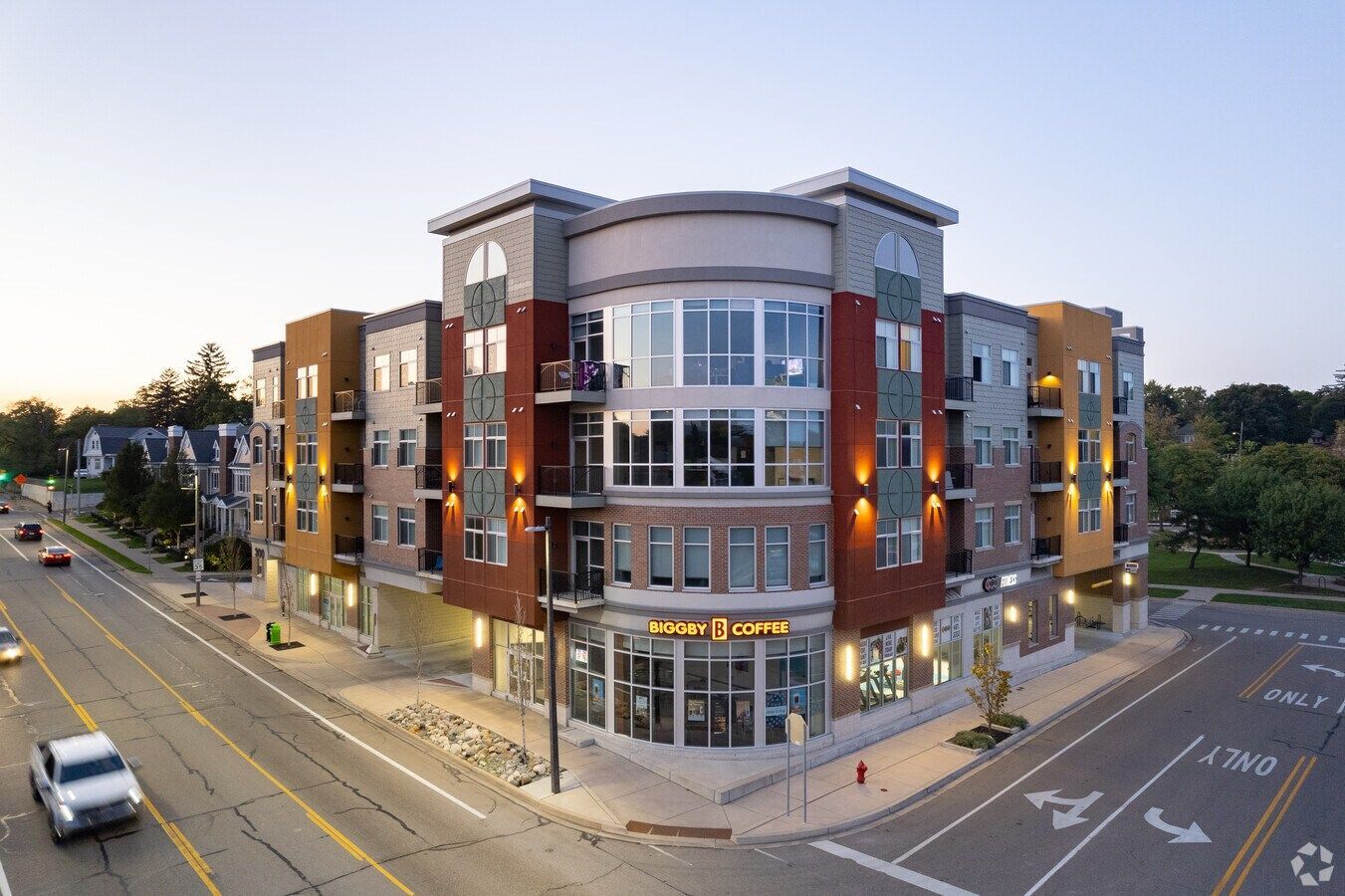 Multi-story apartment building on a city street with corner retail.