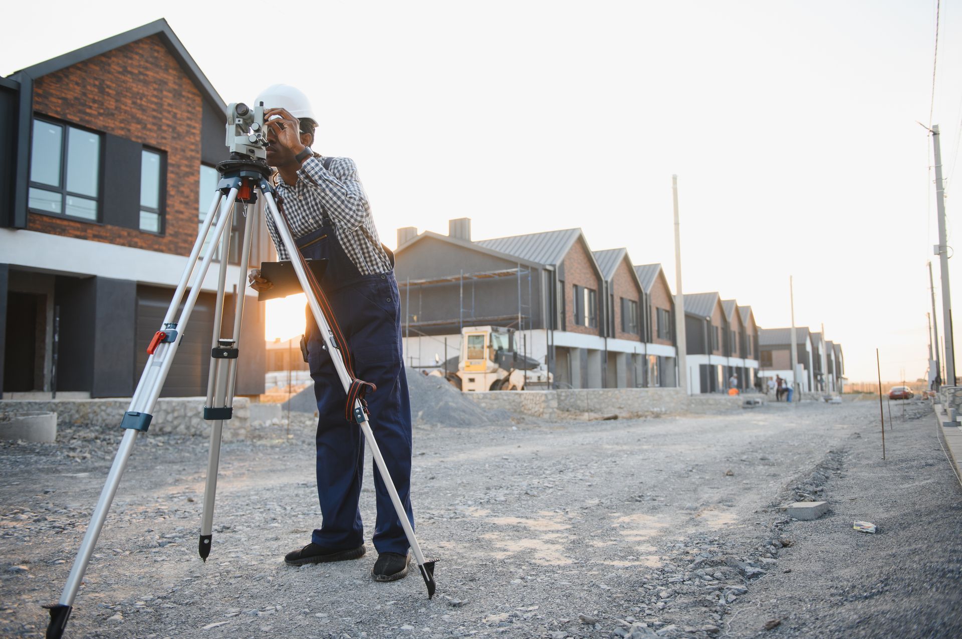 A surveyor is utilizing a total station for land measurement.