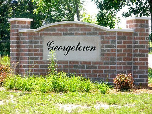 Brick entrance sign reading