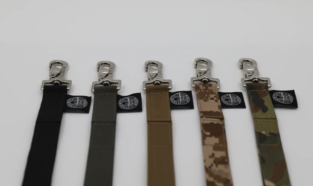Six fabric straps in various colors with a label, displayed vertically.