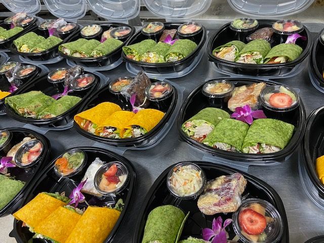 A variety of food in plastic containers on a table