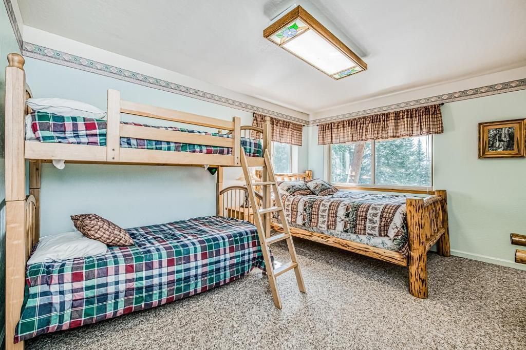 Kids’ bedroom with bunk bed, twin bed, and large window seating area