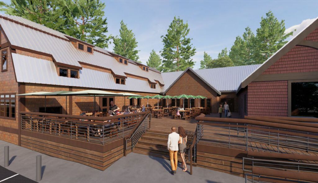 Restaurant exterior with a wooden deck, people, brick facade, and trees.