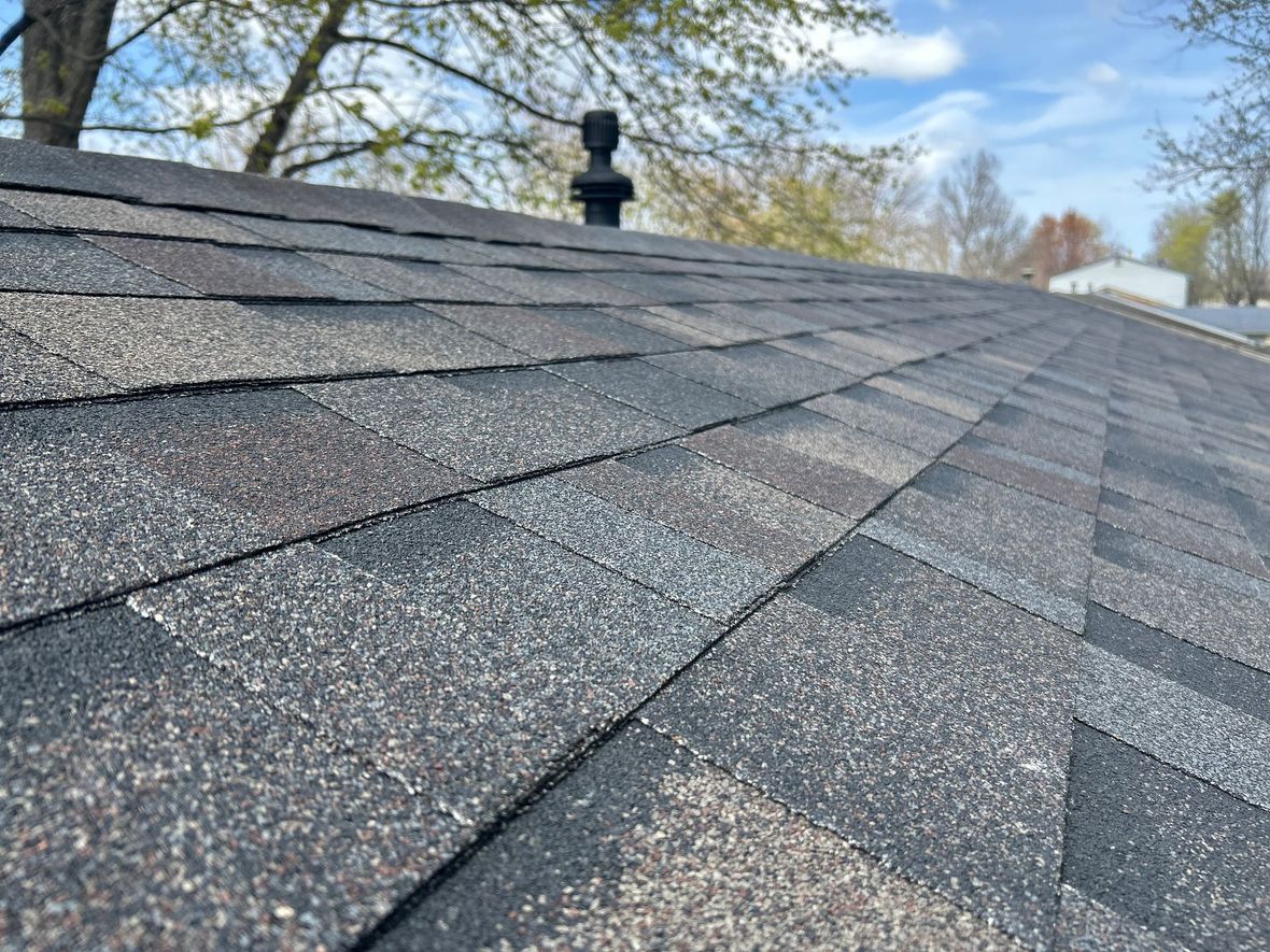 A roof with shingles being installed on it.