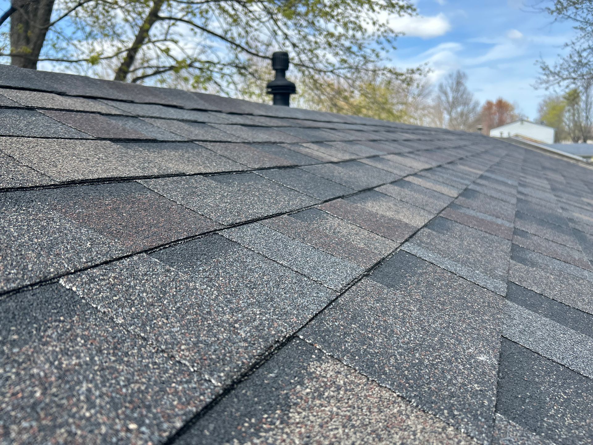 A roof with shingles being installed on it.
