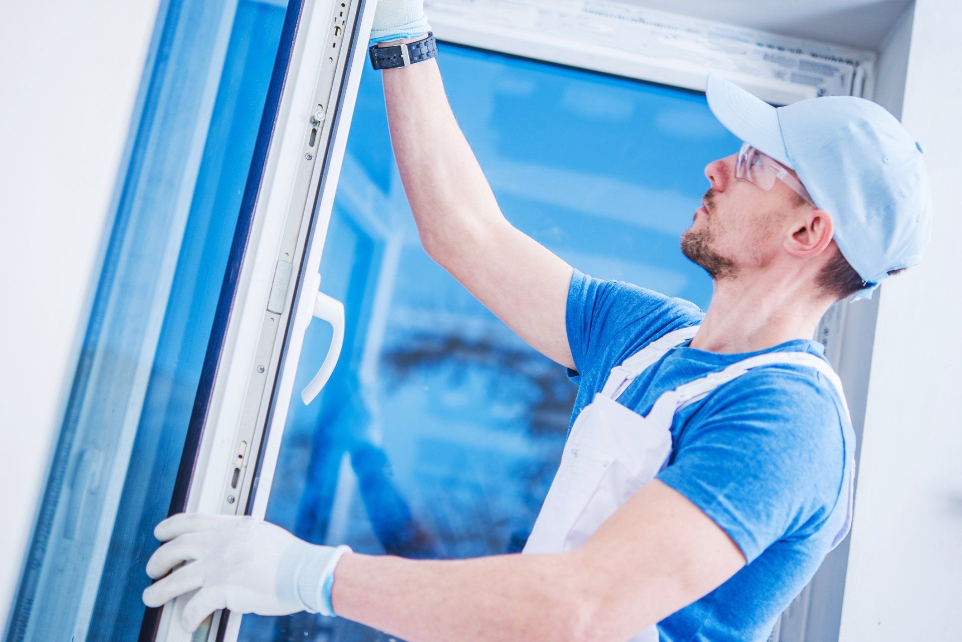 man installing window glass