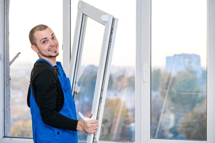man installing window glass