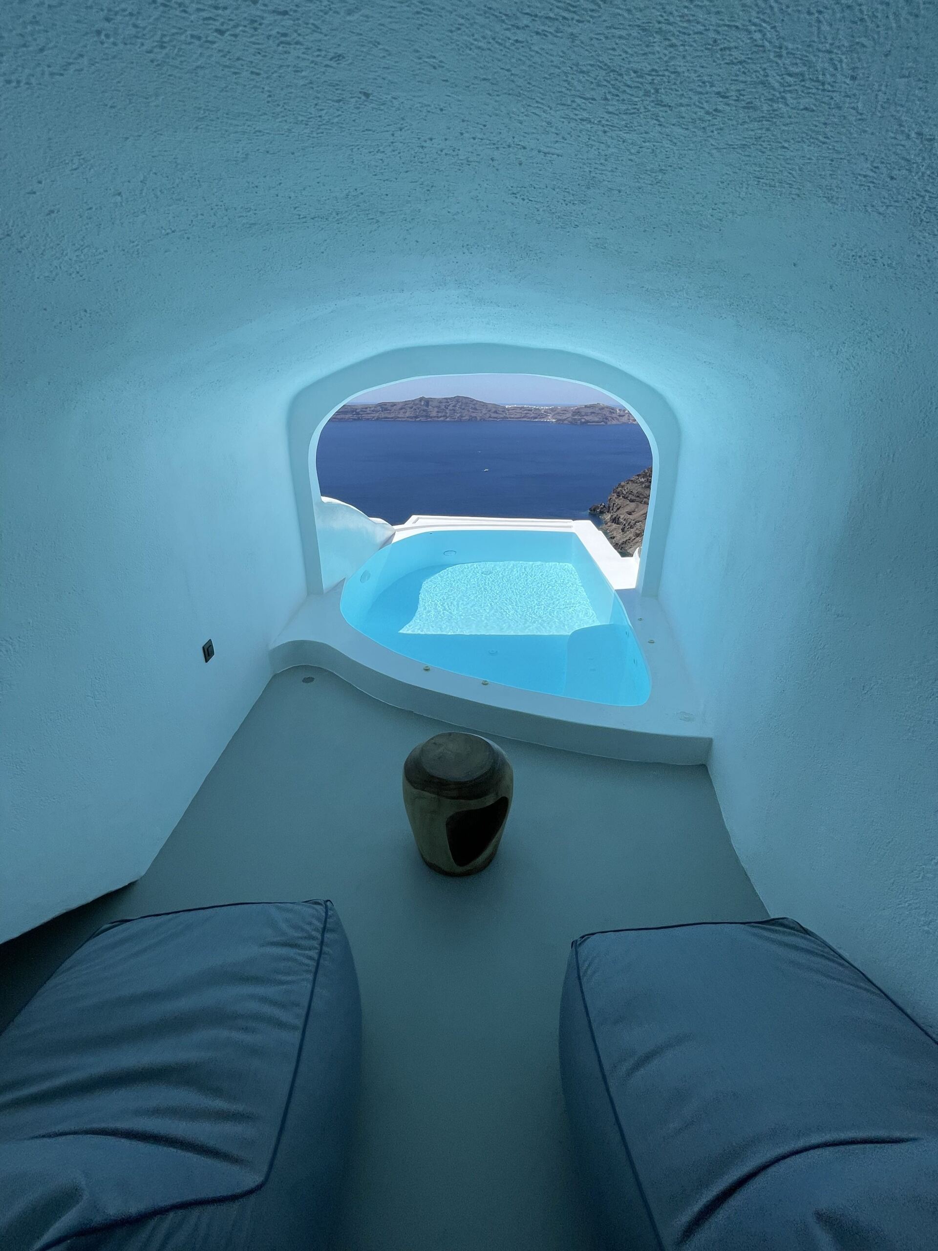 A room with a view of a pool and the ocean