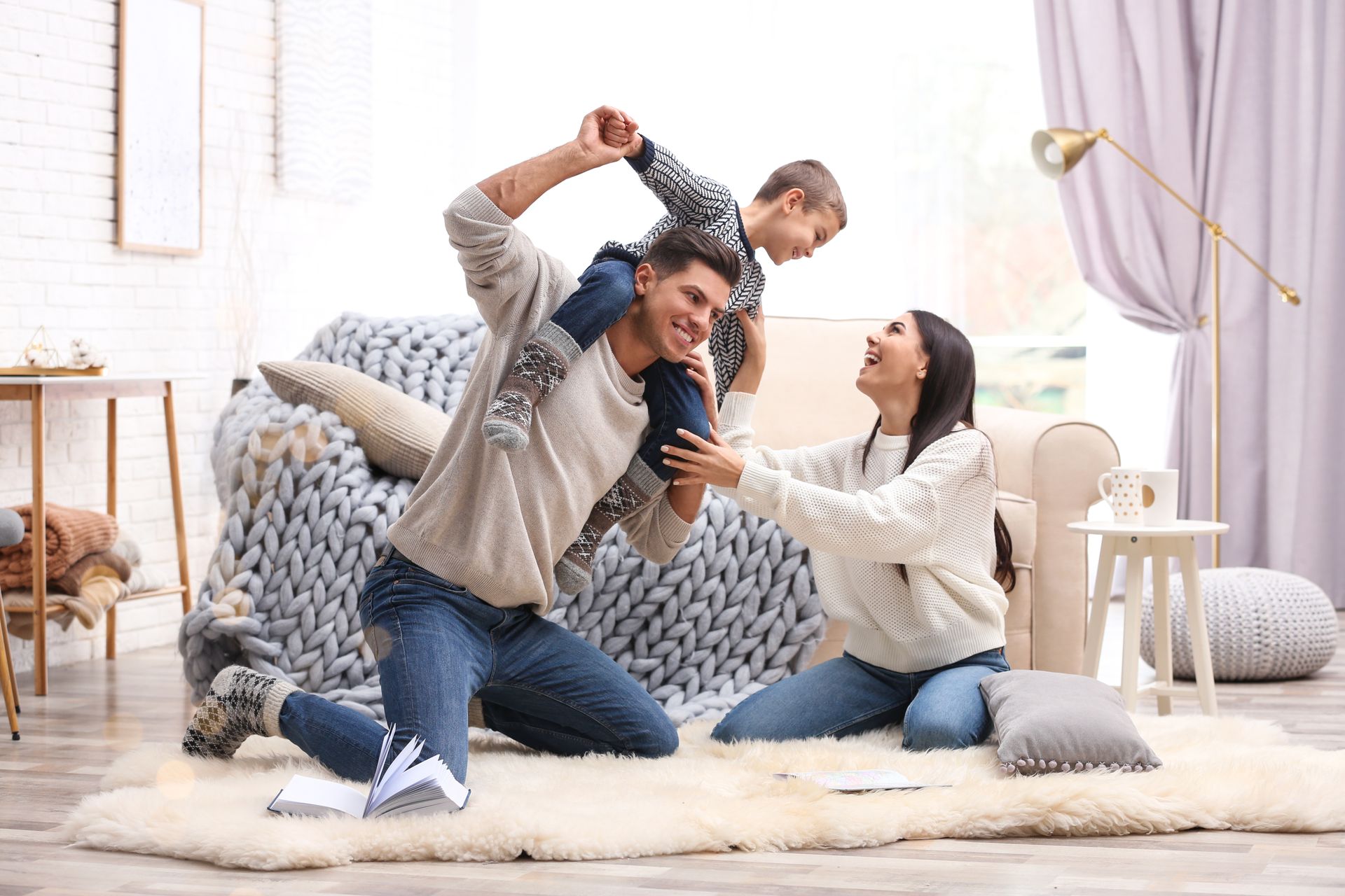 Family playing together on a cozy rug in a bright living room