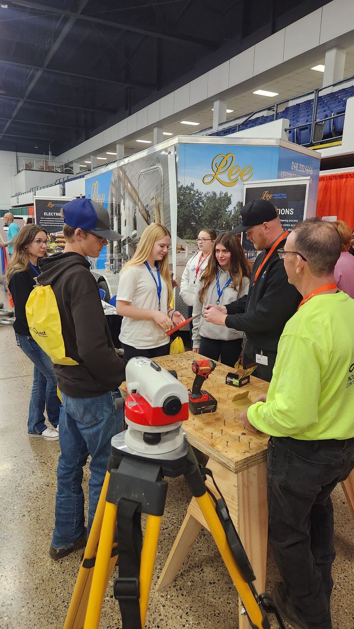 Students standing around a vendor table at MiCareer Quest