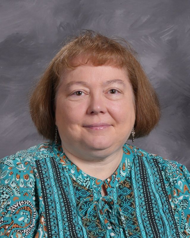 A woman smiles for the camera