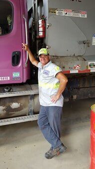 Worker Beside the Purple Truck — Lock Haven, PA — Love Disposal, Inc.