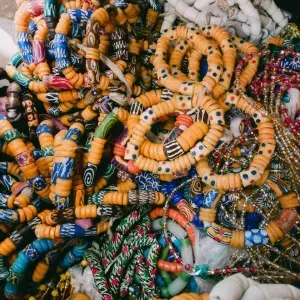 Display of hanging earrings on cards with boxed jewelry on a wooden table in a shop.