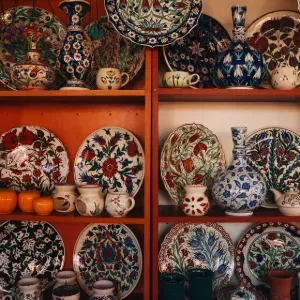 Display of hanging earrings on cards with boxed jewelry on a wooden table in a shop.