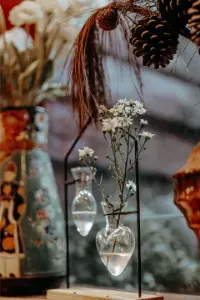 Display of hanging earrings on cards with boxed jewelry on a wooden table in a shop.