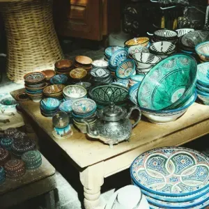 Display of hanging earrings on cards with boxed jewelry on a wooden table in a shop.