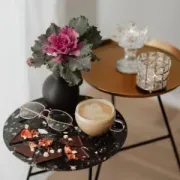 Display of hanging earrings on cards with boxed jewelry on a wooden table in a shop.