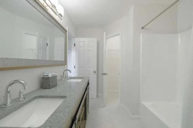 A bathroom with two sinks and a mirror