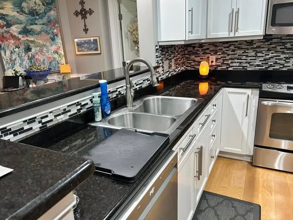 A kitchen with stainless steel appliances and granite counter tops