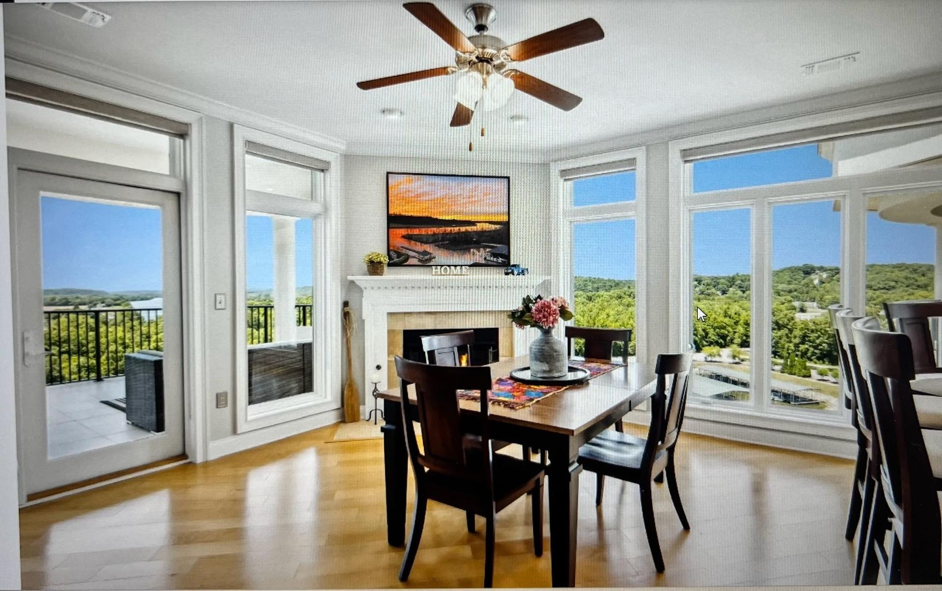 A dining room with a table and chairs and a ceiling fan