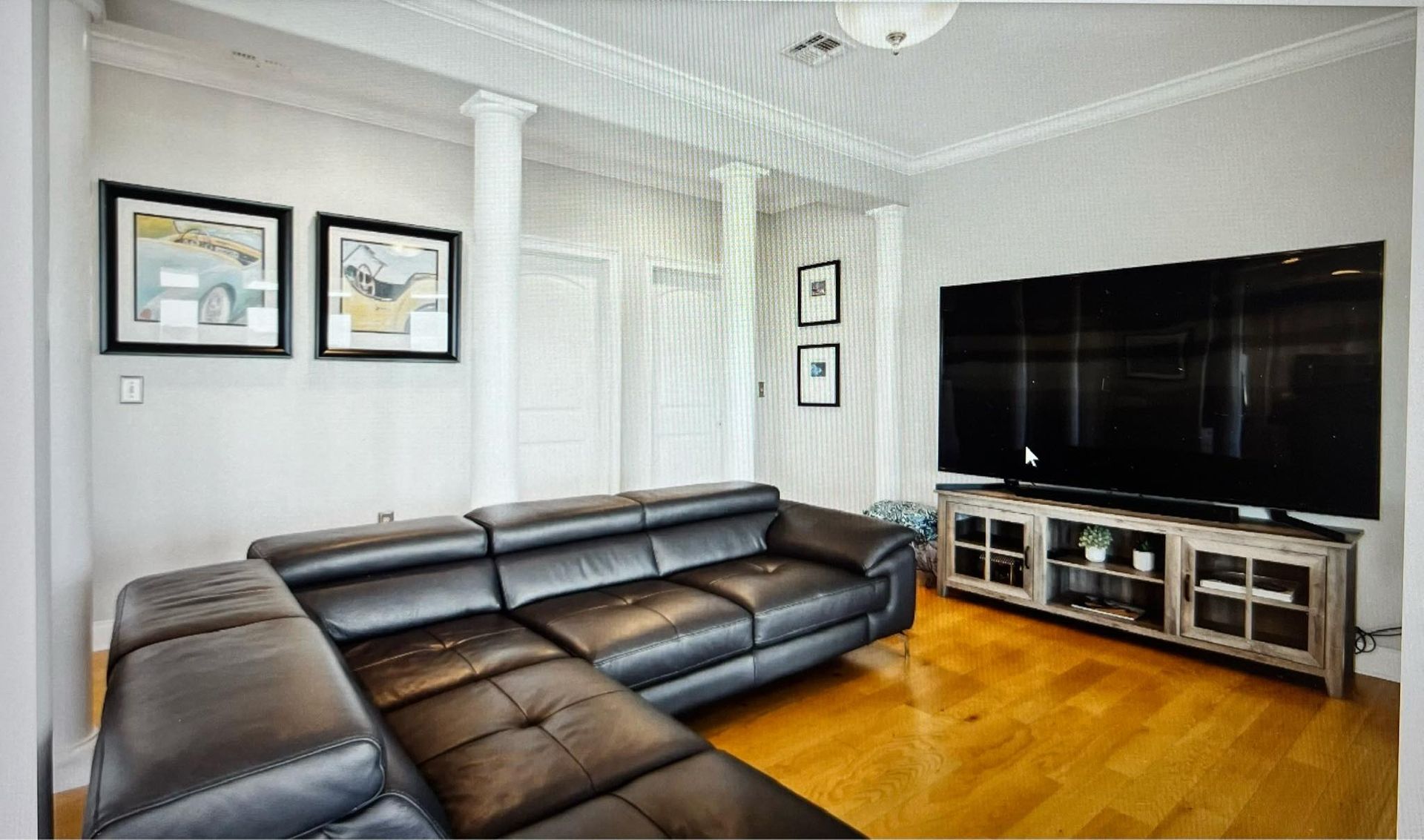 A living room with a couch and a flat screen tv