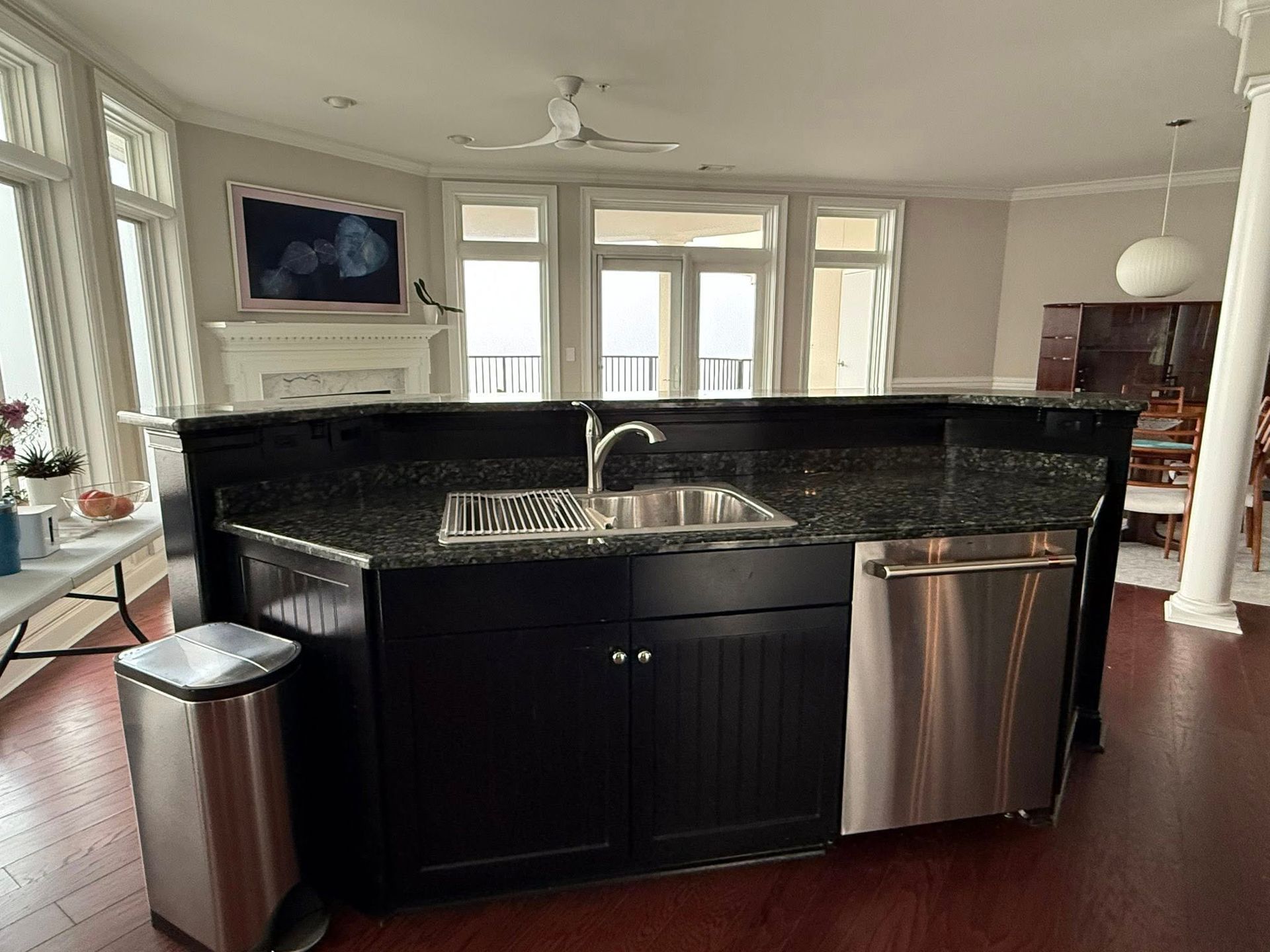 A kitchen with black cabinets and stainless steel appliances