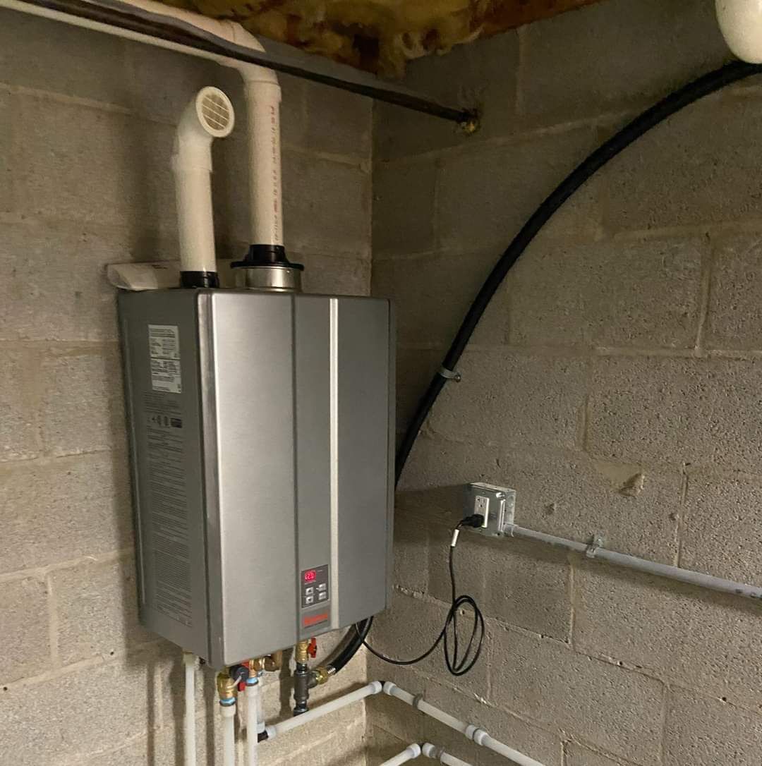 A Water Heater is Hanging on a Brick Wall in a Basement A Water Heater is Hanging on a Brick Wall in a Basement