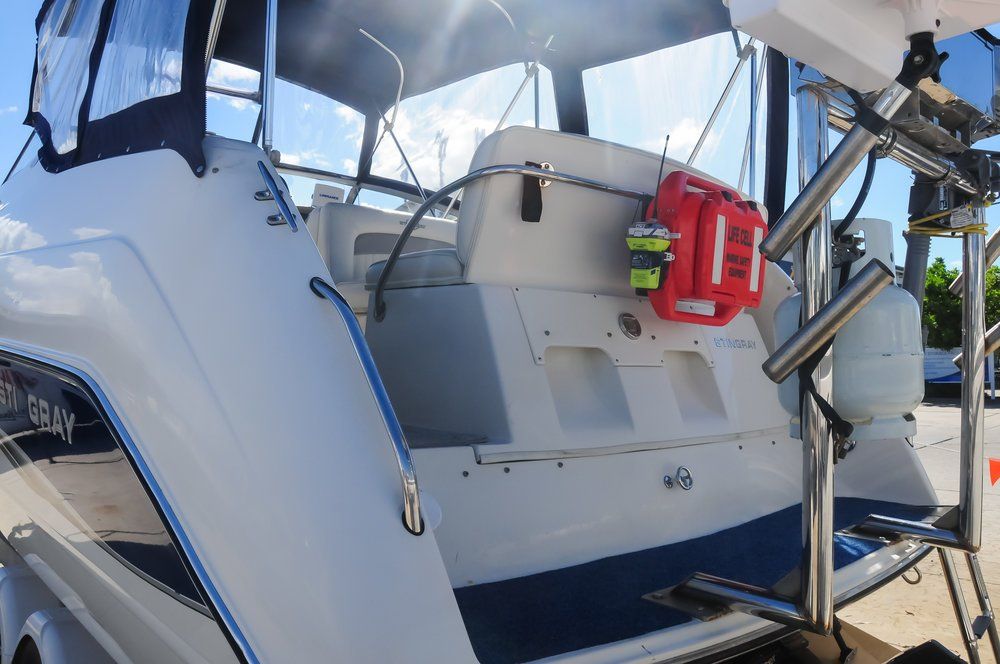 A white boat with a red life preserver on the back of it. LIFECELL products