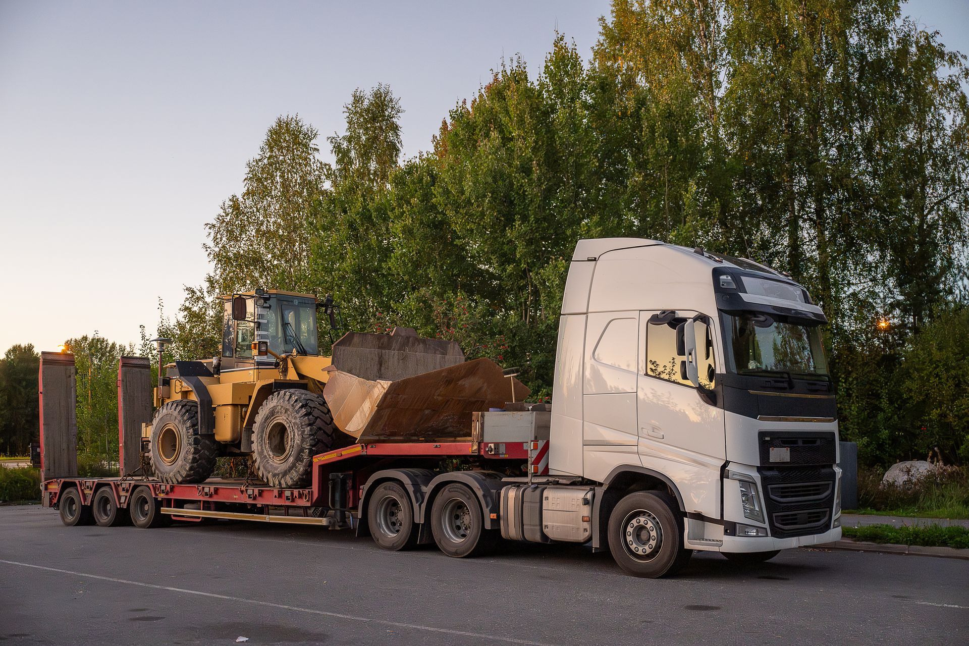 Heavy-duty hauling truck transporting a farm tractor in Chesapeake, VA
