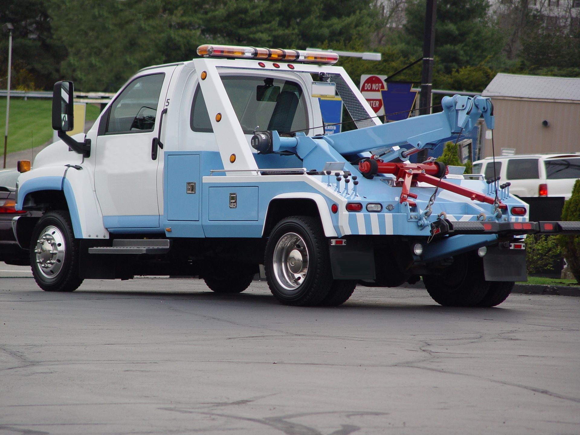 Close-up of a tow truck with a crane attachment, ideal for providing truck towing service.