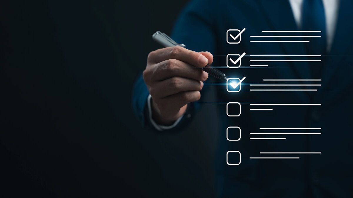 Hand checking a digital checklist with glowing checkmarks on a dark background