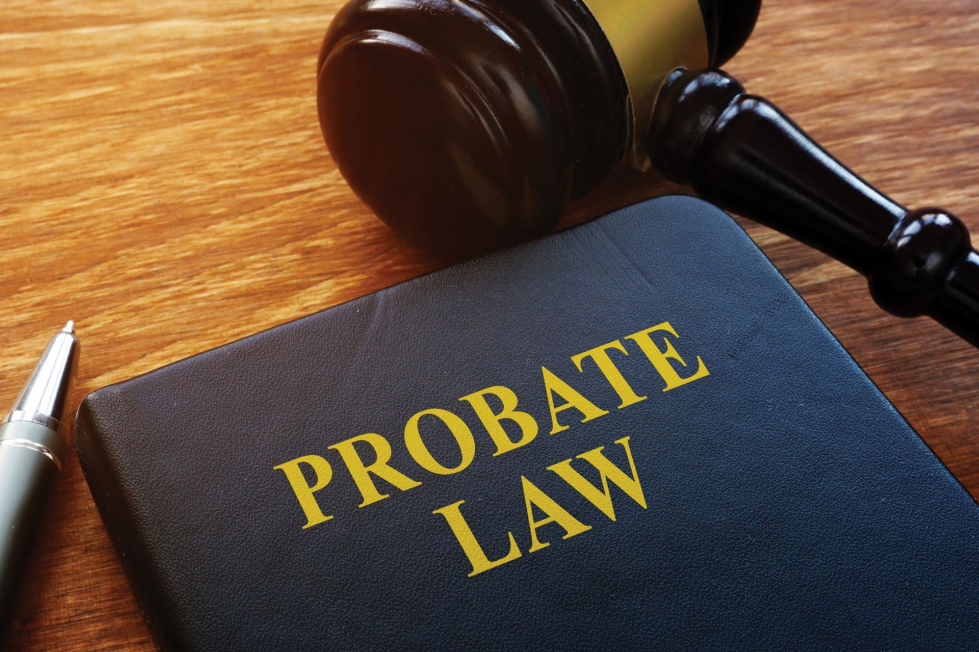 Two Men Are Sitting at a Table With a Gavel and Scales of Justice