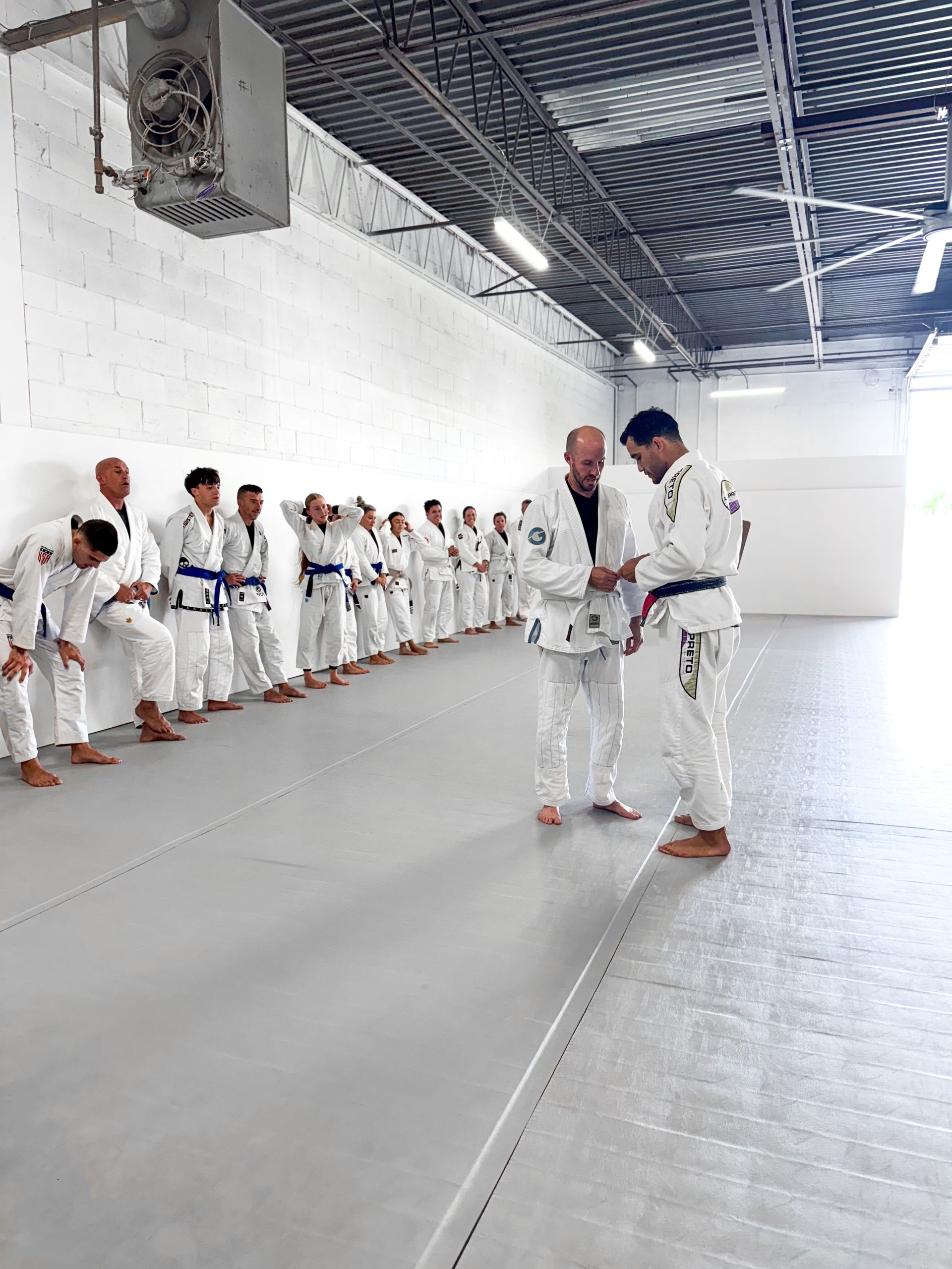 Adults drilling Brazilian Jiu Jitsu techniques at Breathe Jiu Jitsu in Yaphank, NY to build strength