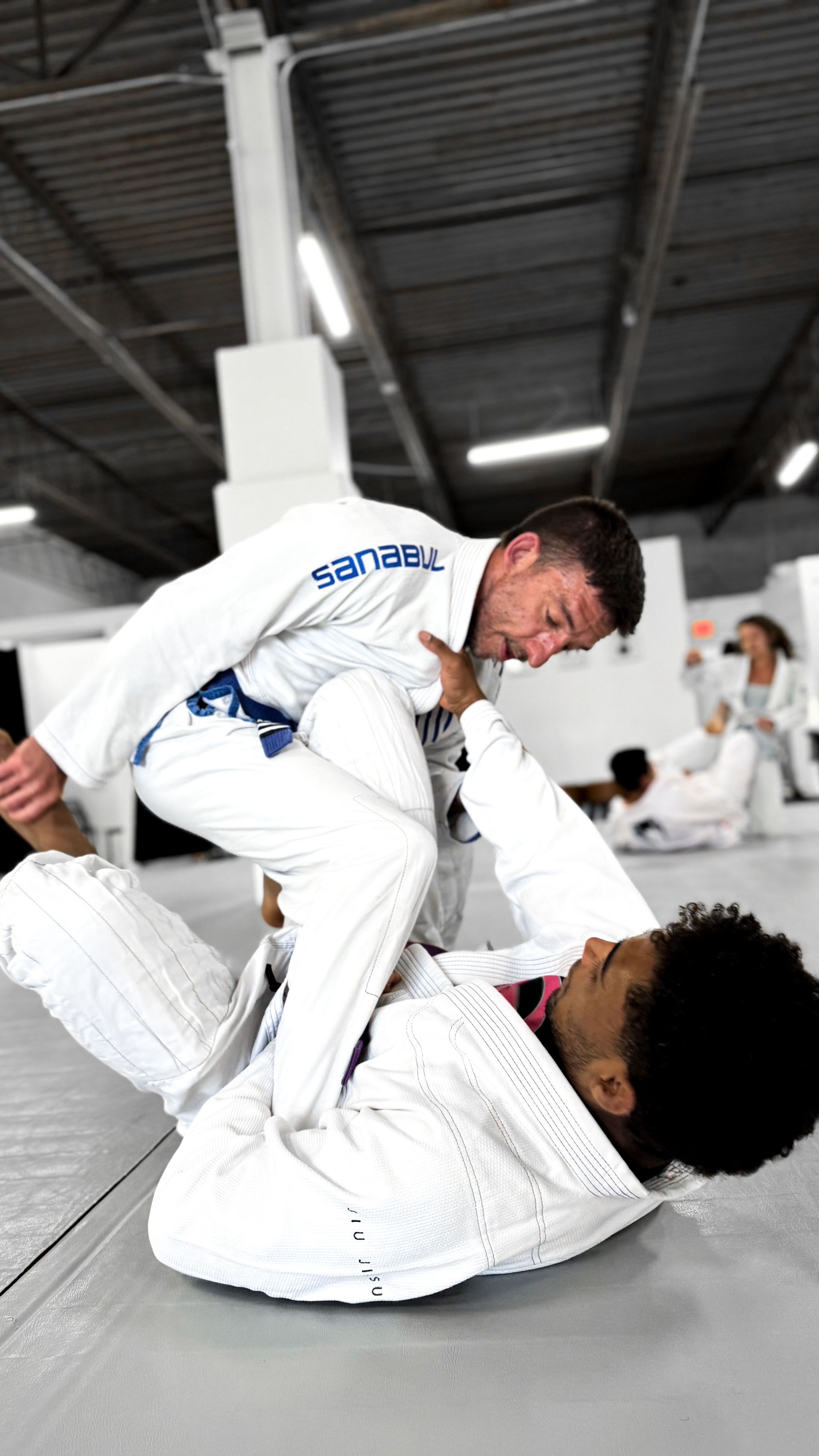 Adults practicing controlled grappling at Breathe Jiu Jitsu in Yaphank, NY to improve mobility.