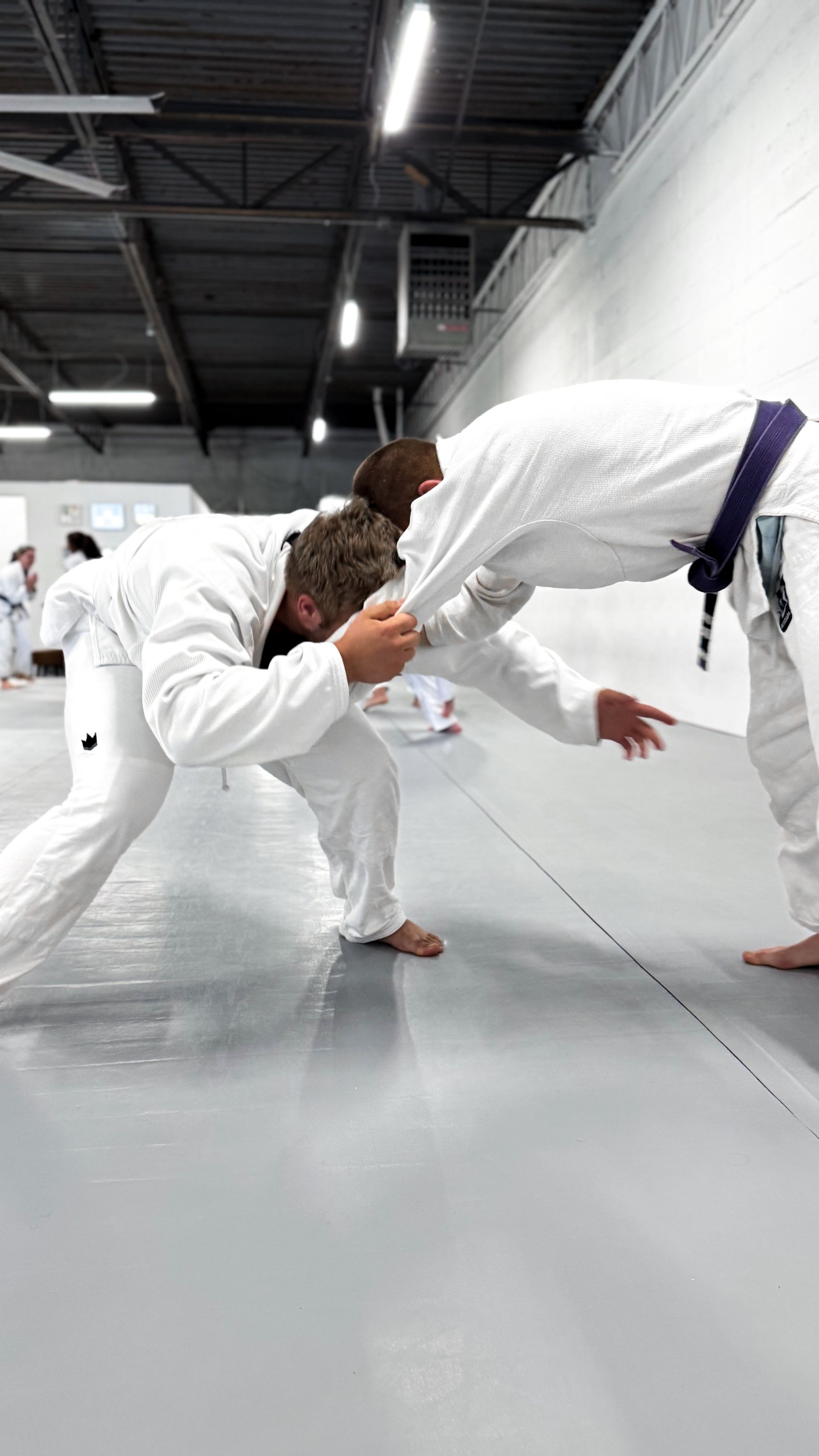 Adults drilling Brazilian Jiu Jitsu techniques at Breathe Jiu Jitsu in Yaphank, NY for stress relief