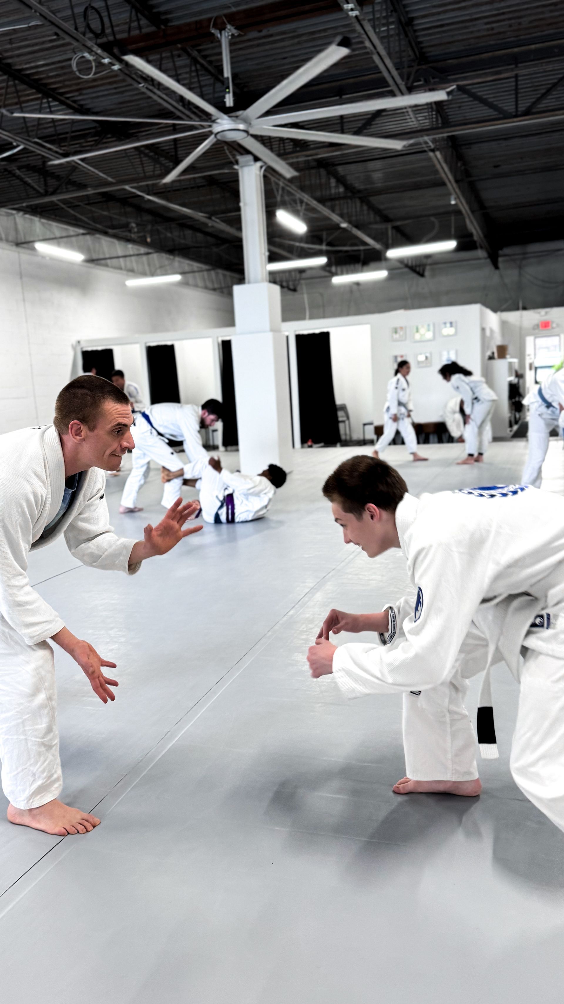 Adult students practicing controlled Jiu Jitsu drills at Breathe Jiu Jitsu in Yaphank, NY.
