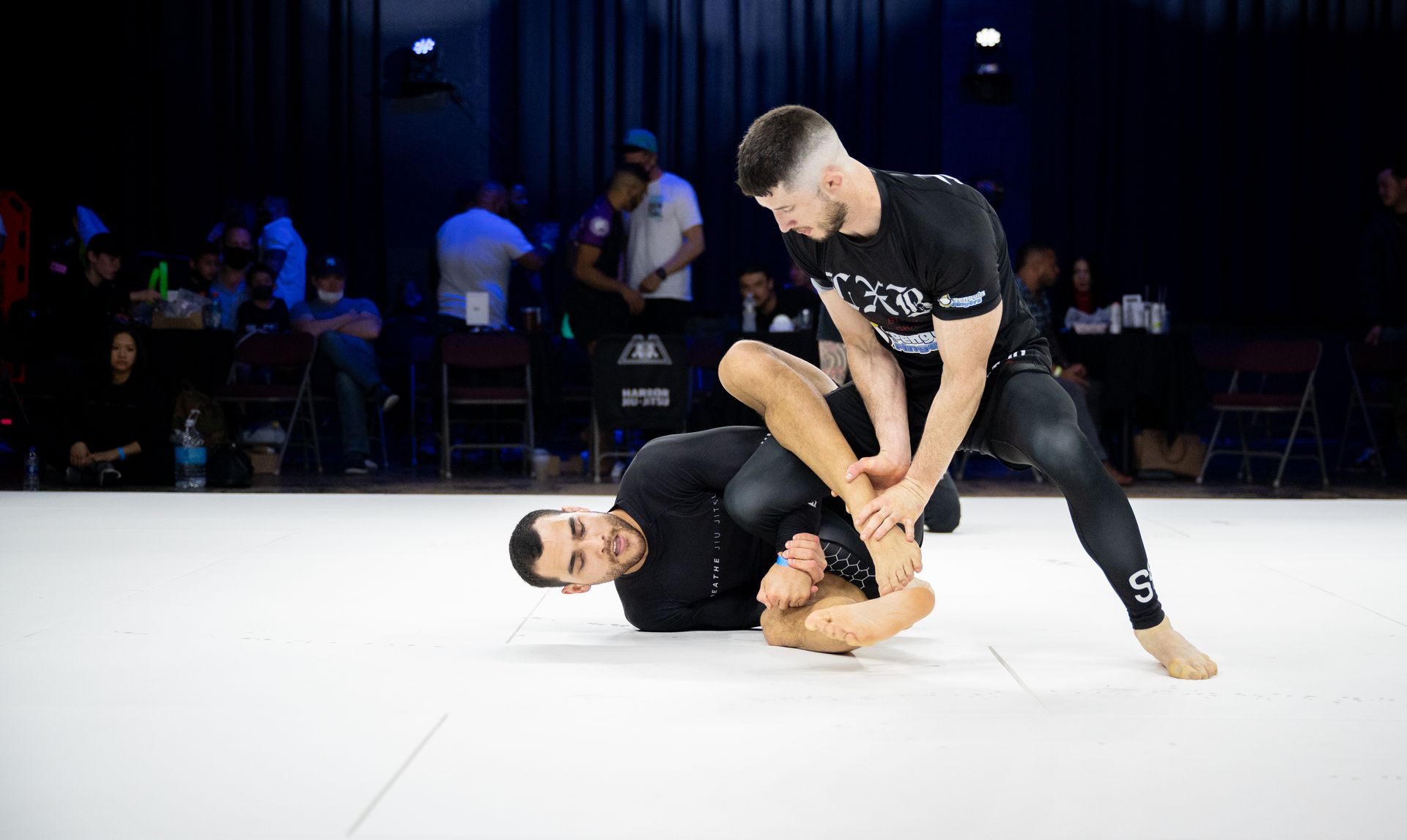 Students practice hip mobility drills at Breathe Jiu Jitsu in Yaphank, NY to improve guard movement and reduce injuries.