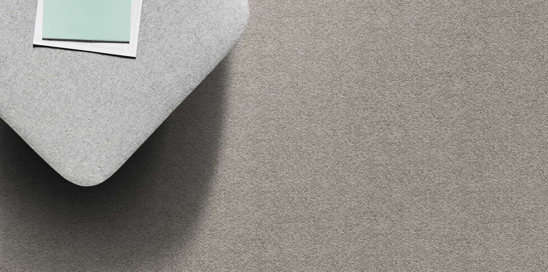 A gray fabric corner with a mint-colored swatch, revealing a textured surface.