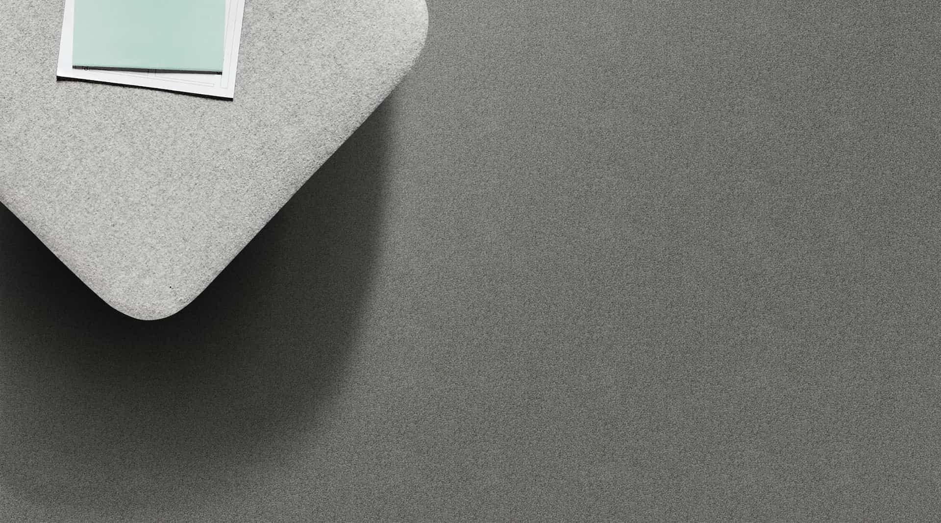 Gray, textured corner with a light blue square and a white rectangle on top.