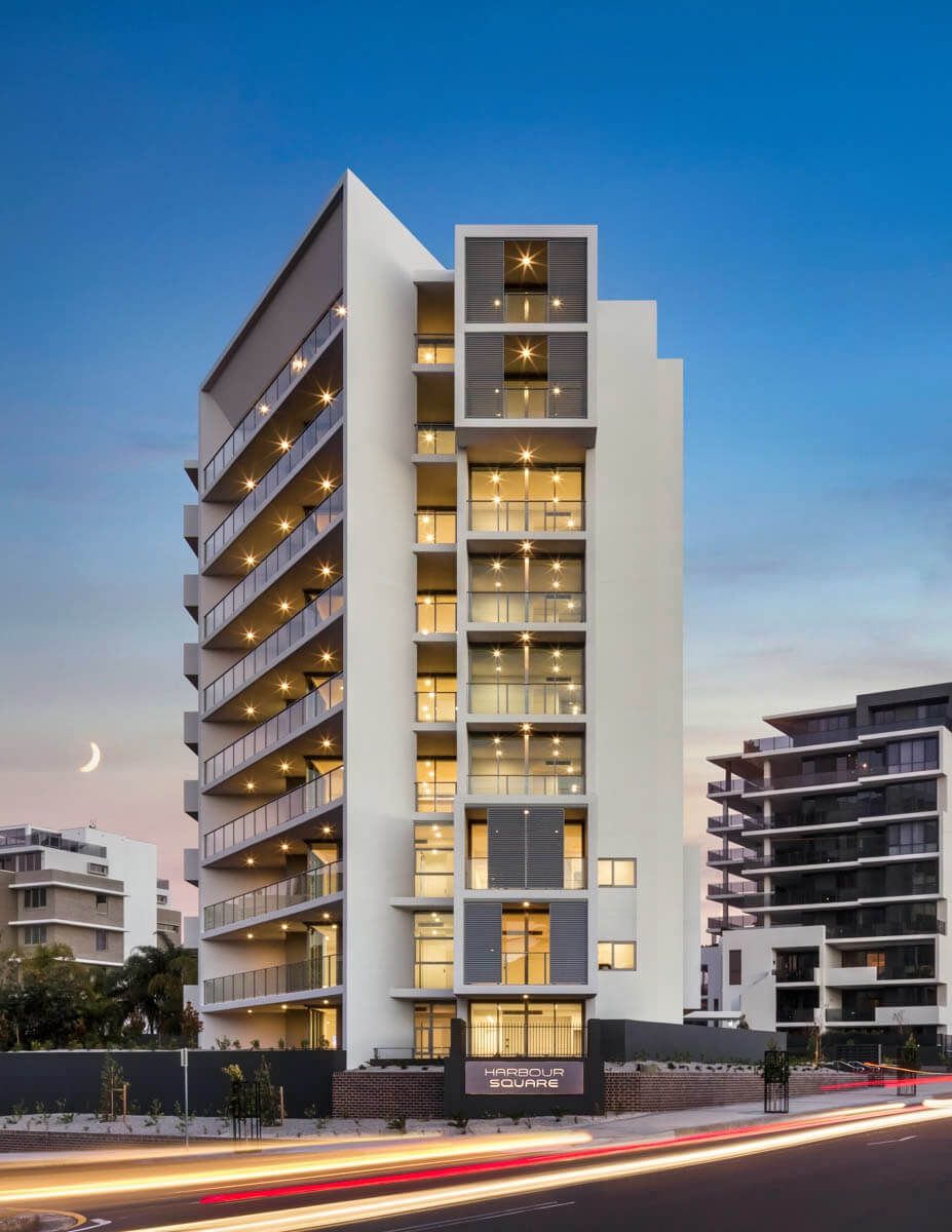 A Tall Building with A Lot of Windows and Balconies — Tony Di Milia Flooring in Unanderra, NSW