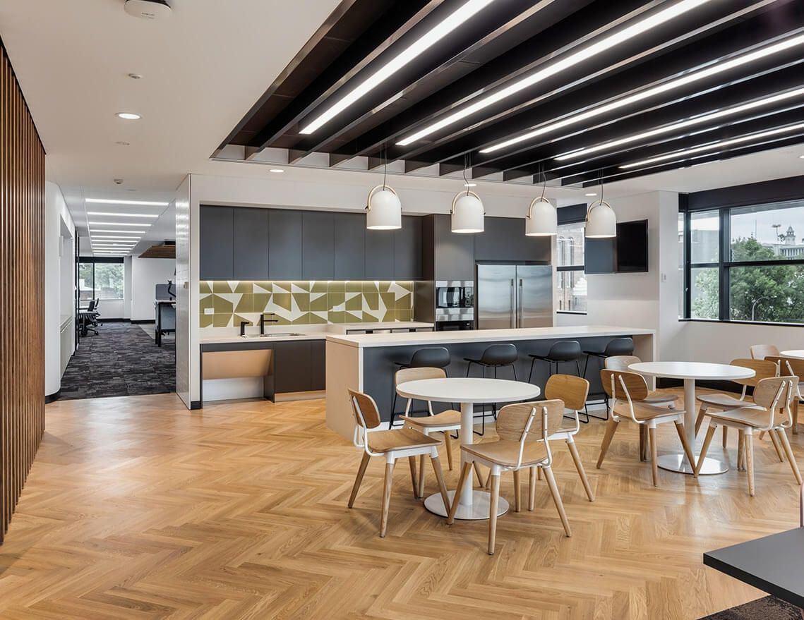 A Large Room with Tables and Chairs in It — Tony Di Milia Flooring in Unanderra, NSW
