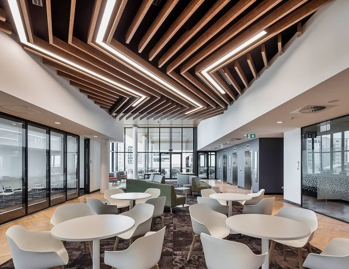 A Large Room with Tables and Chairs and A Wooden Ceiling — Tony Di Milia Flooring in Unanderra, NSW