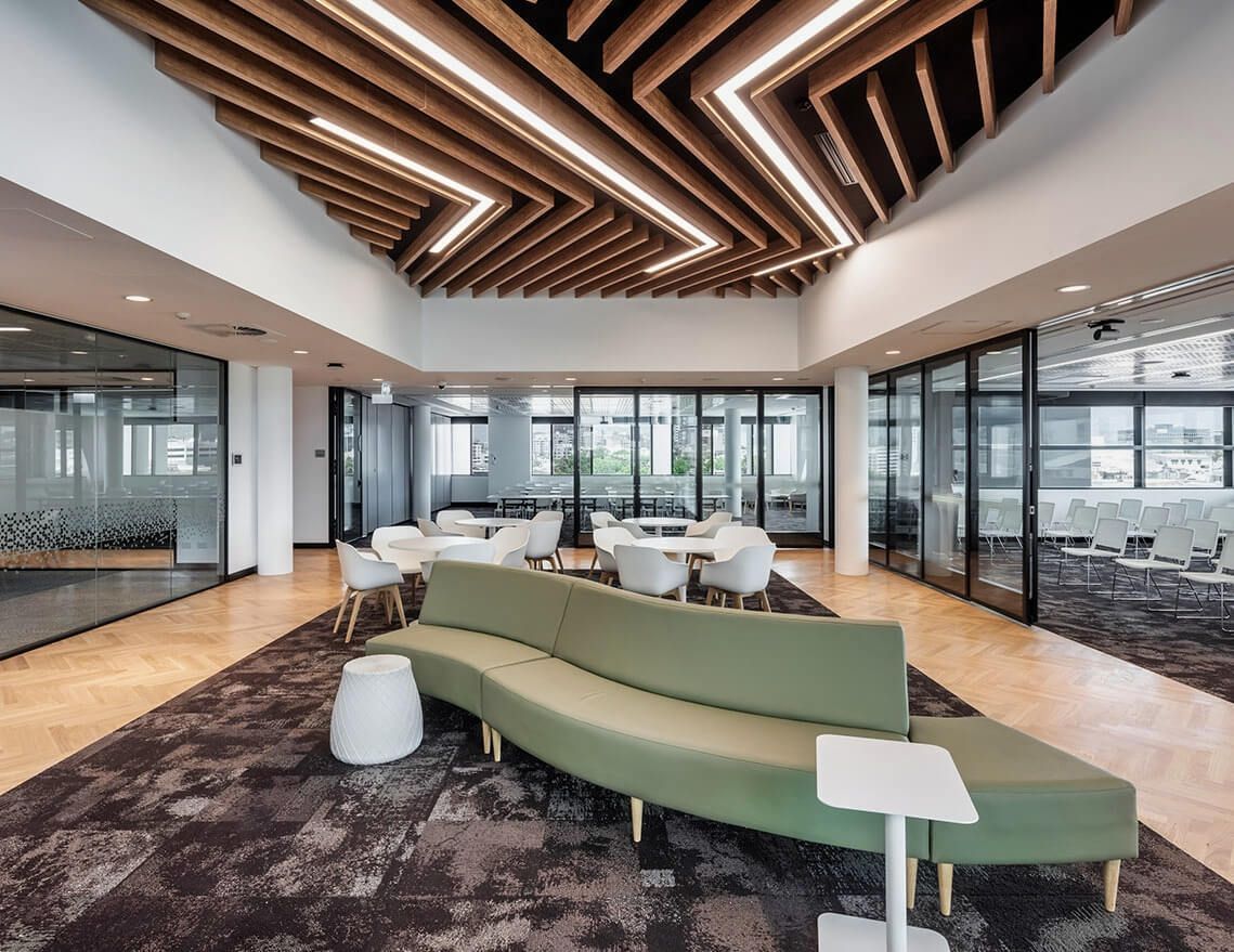 A Large Room with A Couch and Tables in It — Tony Di Milia Flooring in Unanderra, NSW