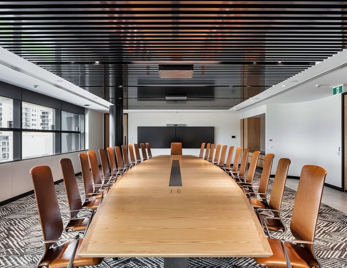A Large Conference Room with A Long Wooden Table and Chairs — Tony Di Milia Flooring in Unanderra, NSW