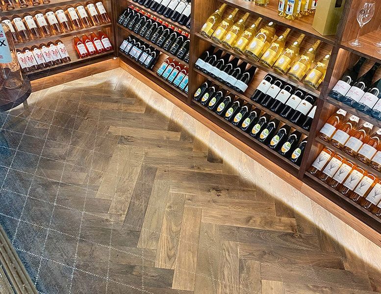A Store Filled with Lots of Bottles of Wine on Shelves — Tony Di Milia Flooring in Unanderra, NSW