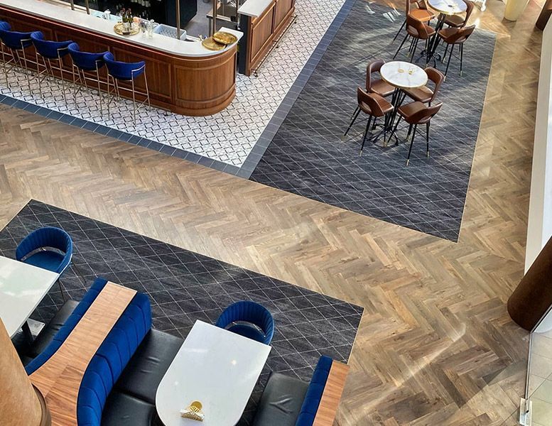 An Aerial View of A Restaurant with Tables and Chairs — Tony Di Milia Flooring in Unanderra, NSW