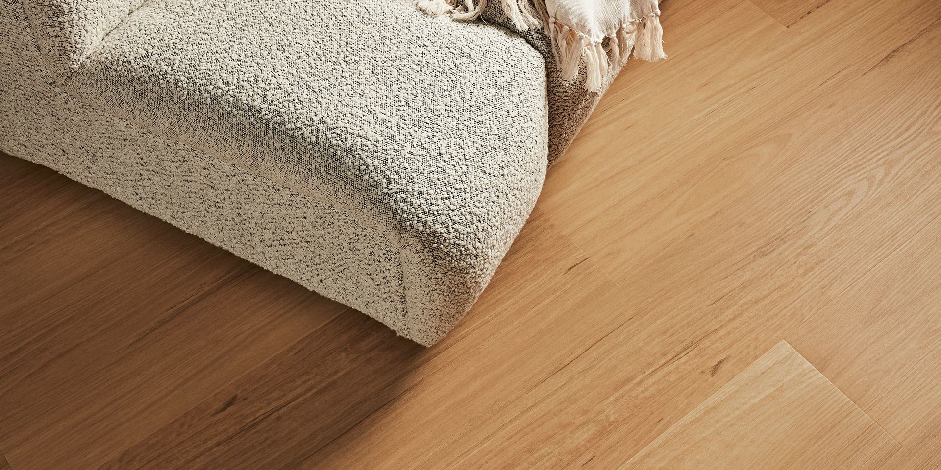 Beige rug on light wood floor.