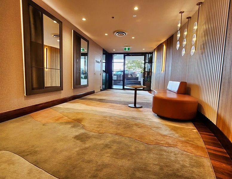 A Hallway with A Couch and A Table in It — Tony Di Milia Flooring in Unanderra, NSW