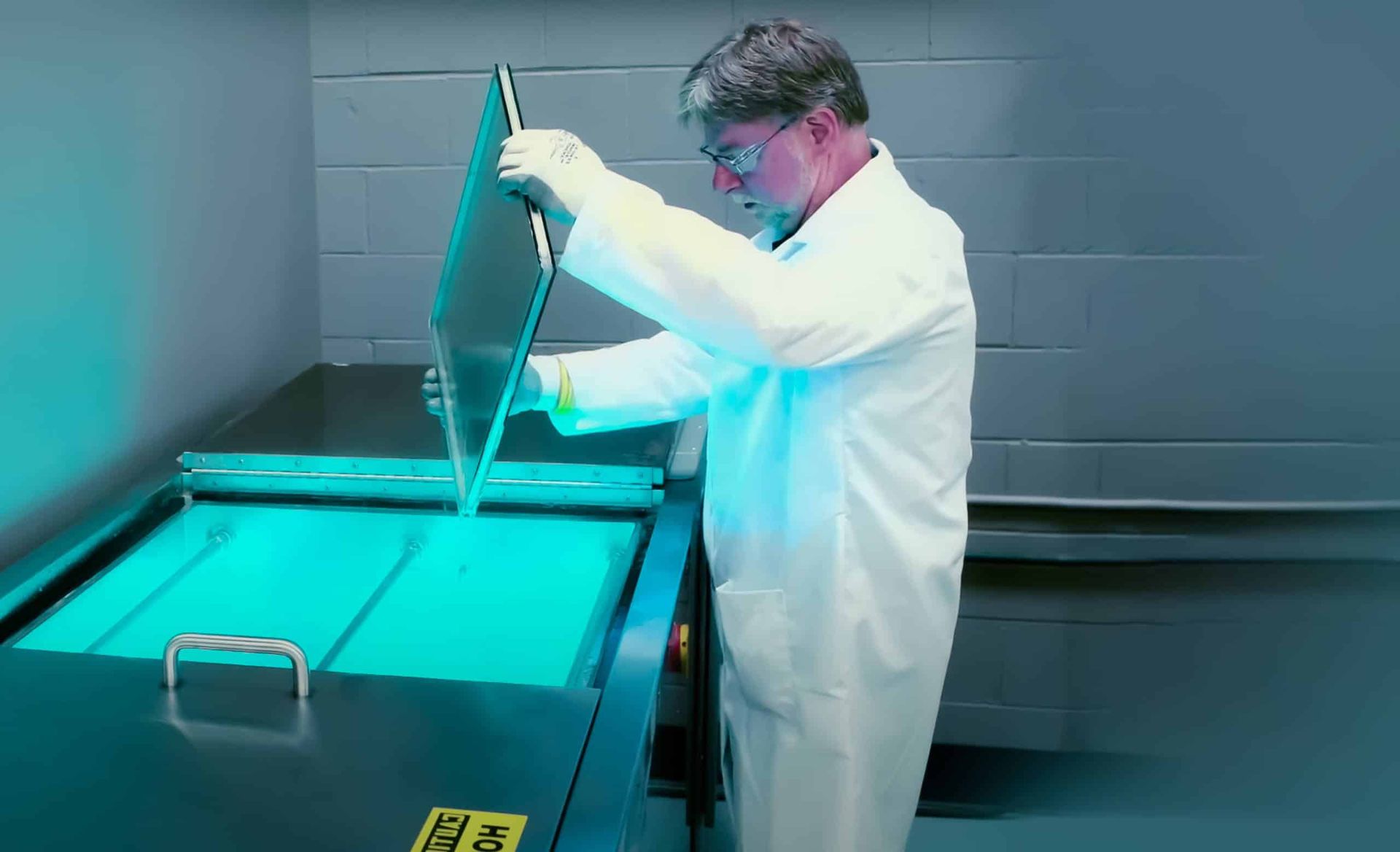Lab technician using illuminated testing equipment, representing scientific analysis and precision work.